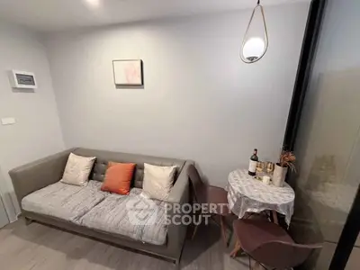 Cozy living room with modern sofa and intimate dining area, perfect for urban living.