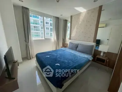 Modern bedroom with large window and stylish decor in a high-rise apartment.