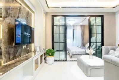 Luxurious modern living room with open view to elegant bedroom, featuring stylish decor and ambient lighting.