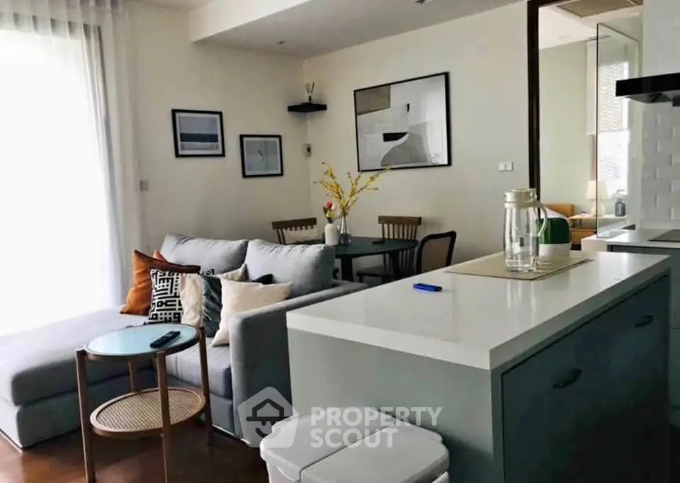 Modern living room with stylish decor and open kitchen layout, perfect for contemporary living.
