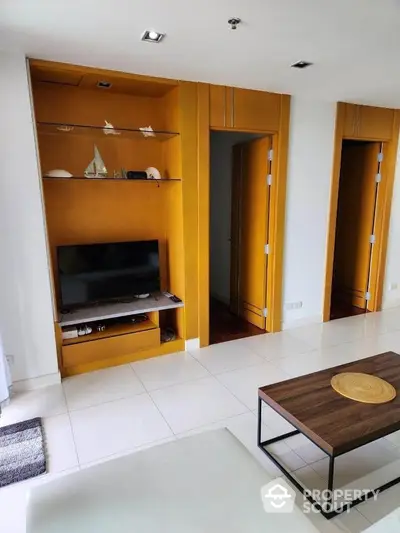 Modern living room with built-in wooden shelves and sleek TV setup