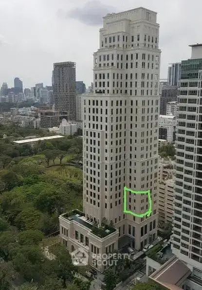 Stunning high-rise building with lush green surroundings and cityscape views.