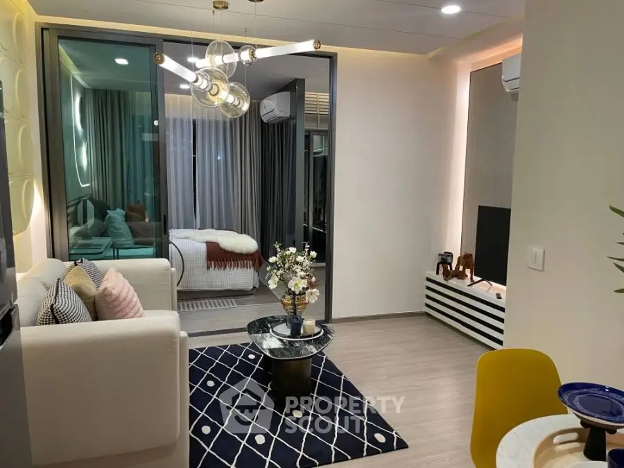 Modern living room with stylish decor and open view into cozy bedroom