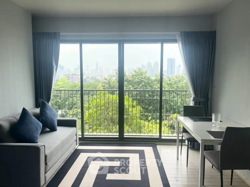 Modern living room with large windows offering stunning cityscape views and elegant decor.