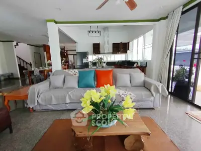Spacious living room with modern decor and open kitchen layout