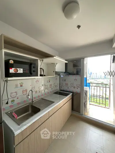 Charming kitchen with city view, featuring modern cabinetry and playful decor.