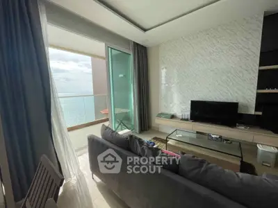 Stunning oceanfront living room with modern decor and expansive balcony view.