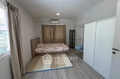 Spacious bedroom with modern decor and ample natural light