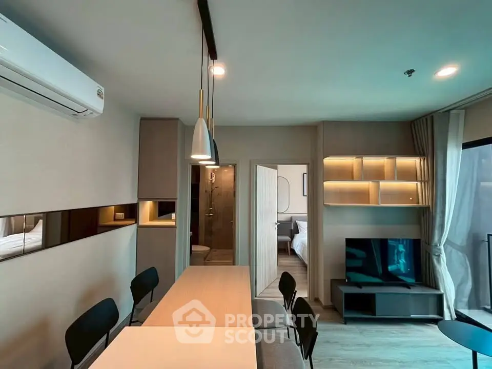 Modern living room with dining area and stylish lighting in open-plan apartment