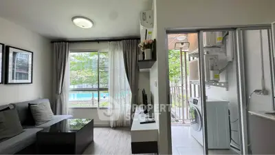 Modern living room with pool view and laundry area in a stylish apartment