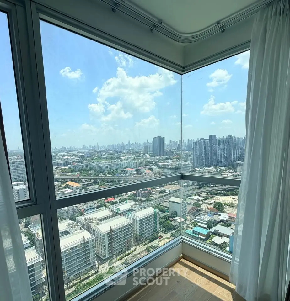 Stunning corner unit with panoramic city views from floor-to-ceiling windows, offering abundant natural light.
