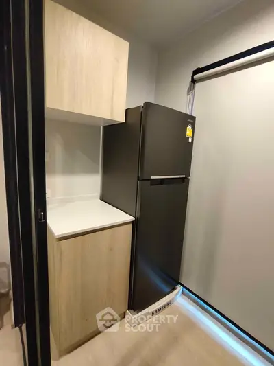 Modern kitchen with sleek fridge and wooden cabinetry