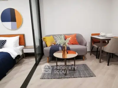 Modern studio apartment with stylish decor, featuring a cozy living area and dining space.