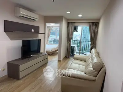 Modern living room with leather sofa and city view balcony in high-rise apartment