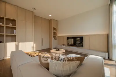 Spacious modern living room with elegant wooden cabinetry and cozy seating area.