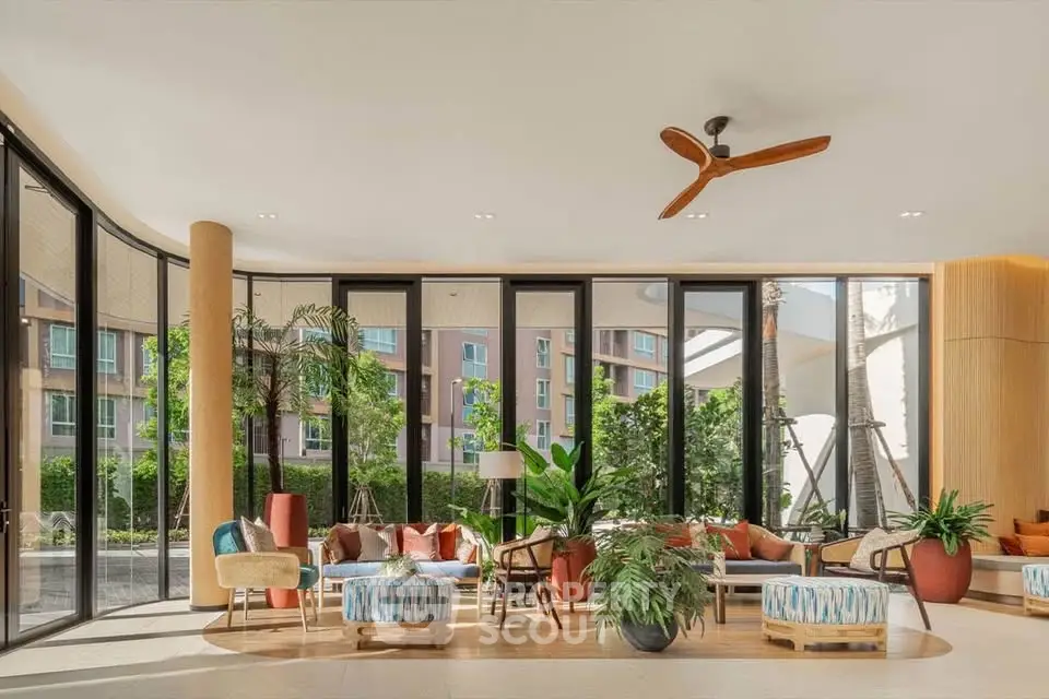 Luxurious modern living room with large windows and stylish decor in a high-end apartment complex.