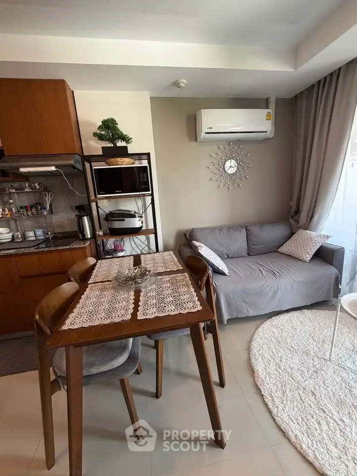 Cozy living room with dining area and modern kitchen appliances