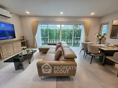 Spacious modern living room with elegant decor and garden view, perfect for relaxation and entertainment.