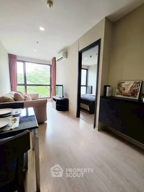 Modern apartment living room with cozy seating and large window view