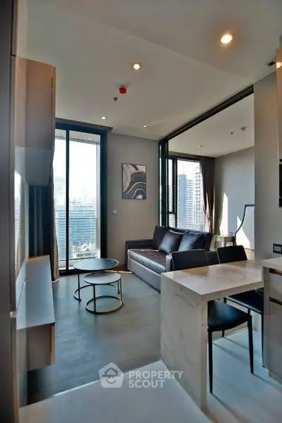Modern living room with city view, stylish furniture, and open layout in high-rise apartment.