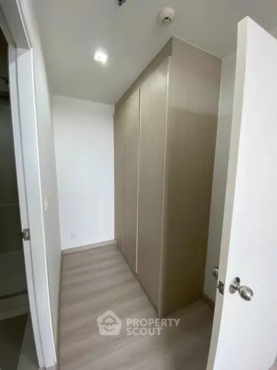 Modern storage room with sleek wooden cabinets and minimalist design