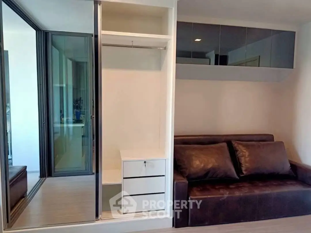 Modern living room with sleek sofa and built-in storage, perfect for urban living.