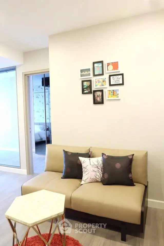 Modern living room with stylish sofa and wall art in a cozy apartment setting.