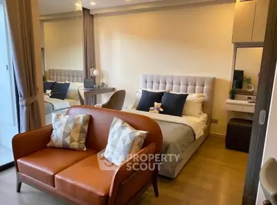Stylish modern bedroom with cozy seating area and elegant decor