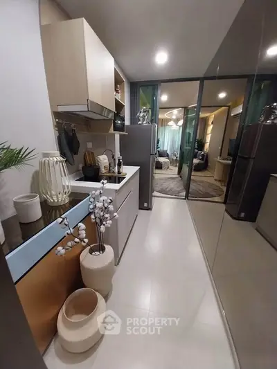 Modern kitchen with sleek design and open layout leading to living area.