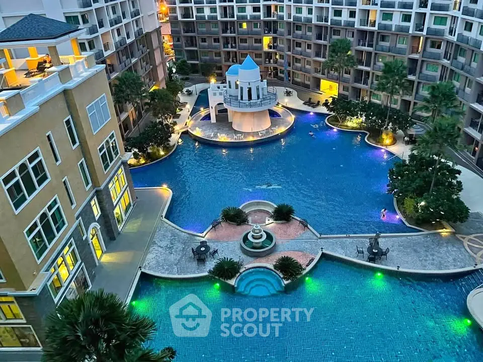 Luxurious apartment complex with stunning illuminated pool and elegant architecture.