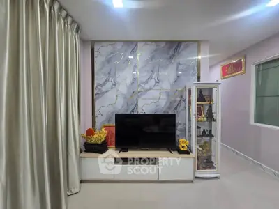 Elegant living room with marble accent wall and modern TV setup