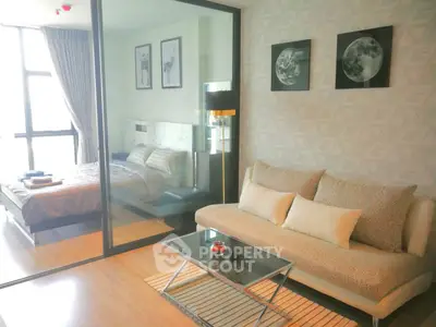 Modern living room with glass partition and cozy bedroom view