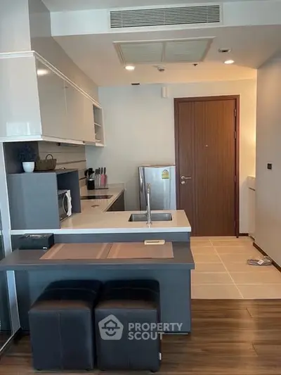 Modern kitchen with sleek design, featuring a compact layout and stylish appliances, perfect for urban living.