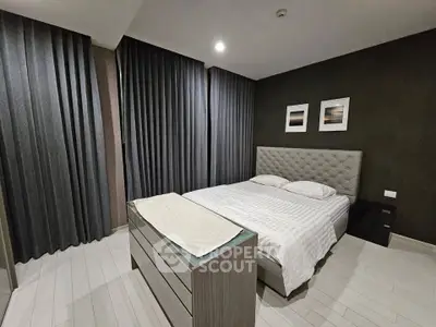 Modern bedroom with stylish decor and elegant furnishings, featuring a cozy bed and sleek dresser.