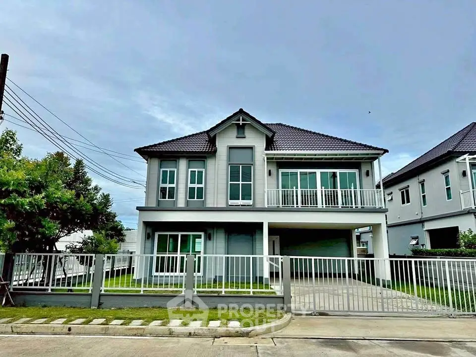 Modern two-story house with spacious driveway and lush green lawn
