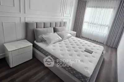 Modern bedroom with elegant decor and natural light, featuring a plush bed and stylish curtains.