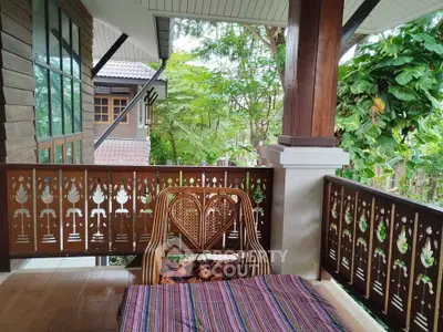 Charming balcony with traditional wooden decor and lush garden view