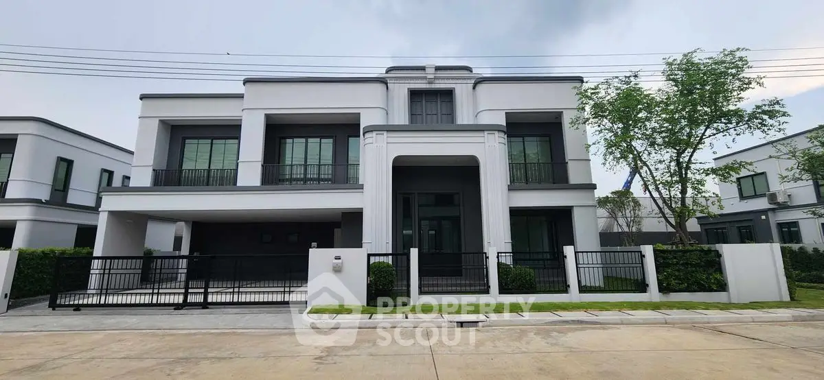 Stunning modern two-story house with sleek design and spacious driveway in a serene neighborhood.