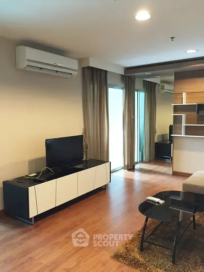 Modern living room with sleek furniture and air conditioning, featuring a cozy ambiance and stylish decor.