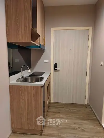 Compact modern kitchen with wooden cabinets and sleek design