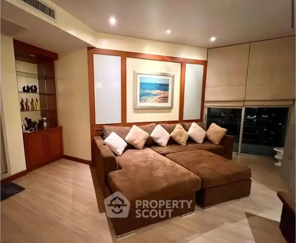Spacious living room with cozy sectional sofa and elegant decor, perfect for relaxation and entertainment.