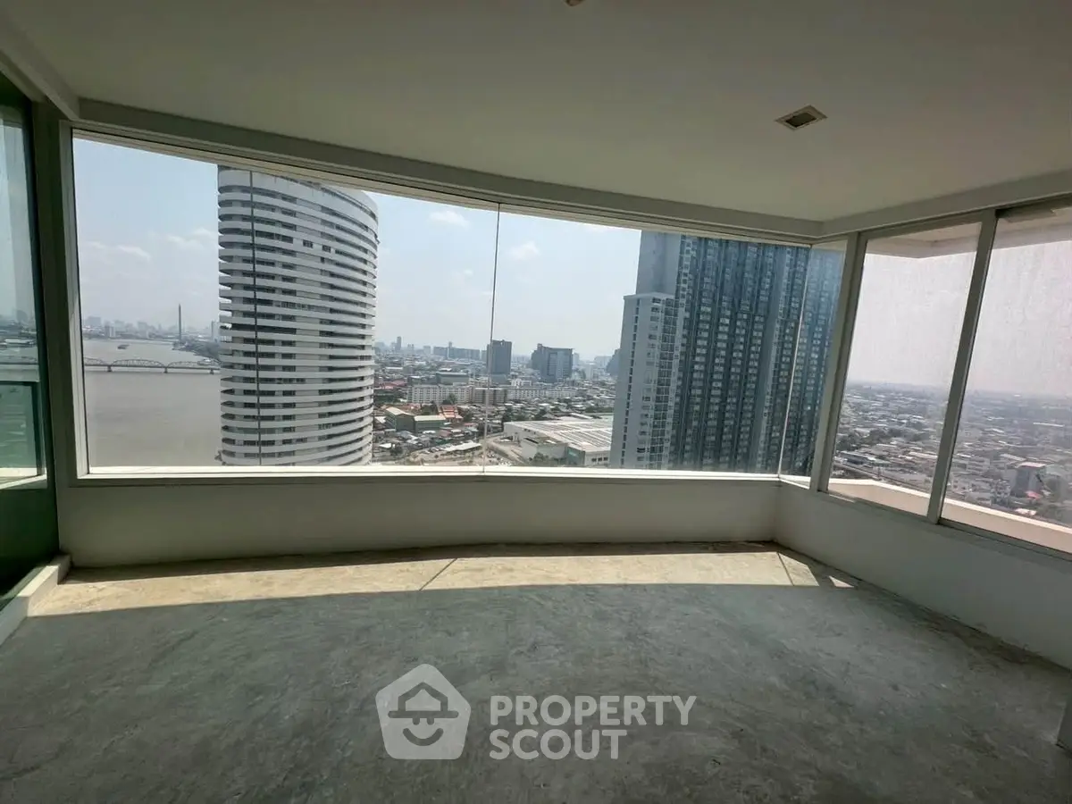 Spacious corner unit with panoramic city and river views from floor-to-ceiling windows.