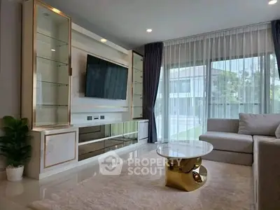 Luxurious living room with modern decor, large windows, and elegant furniture in a stylish home.