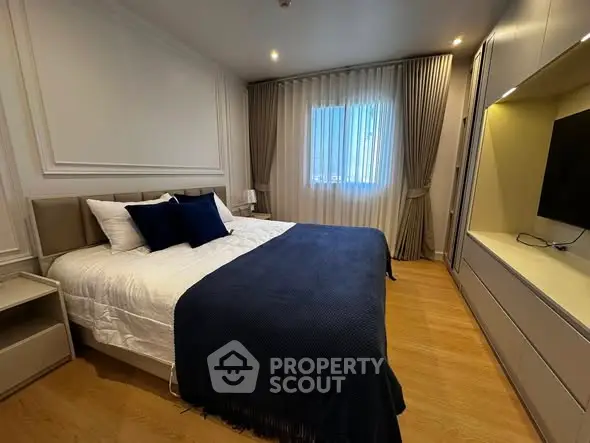 Luxurious bedroom with elegant decor and cozy ambiance, featuring a plush bed and stylish furnishings.