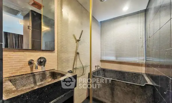 Luxurious modern bathroom with sleek stone sink and spacious bathtub