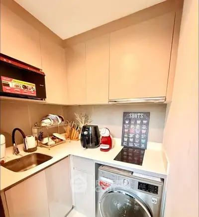 Compact kitchen with modern appliances and sleek cabinetry