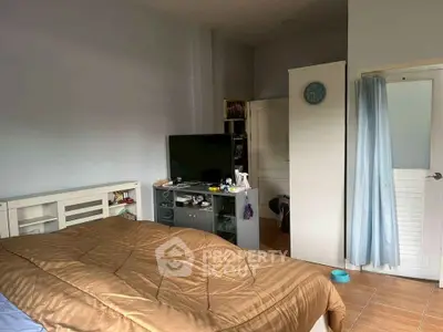 Cozy bedroom with modern decor and TV, ideal for relaxation.