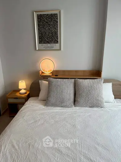 Cozy bedroom with stylish decor and soft lighting, perfect for relaxation.