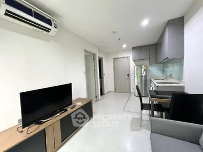 Modern open-layout living room with sleek kitchen and stylish furniture in a contemporary apartment.