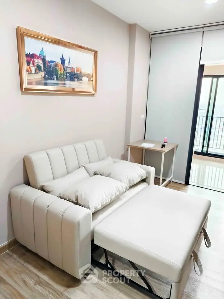 Modern living room with sofa bed and balcony view